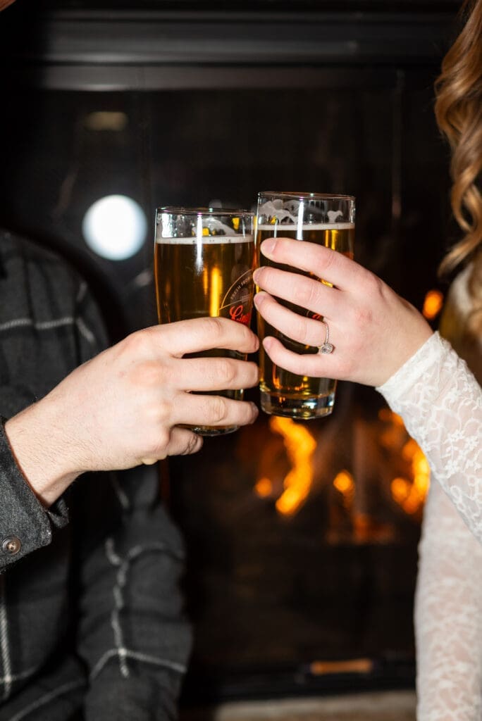 Beers cheers at the Leinie Lodge in Chippewa Falls WI. Photo by Spirited Sage Photography, an Eau Claire Wisconsin wedding photographer