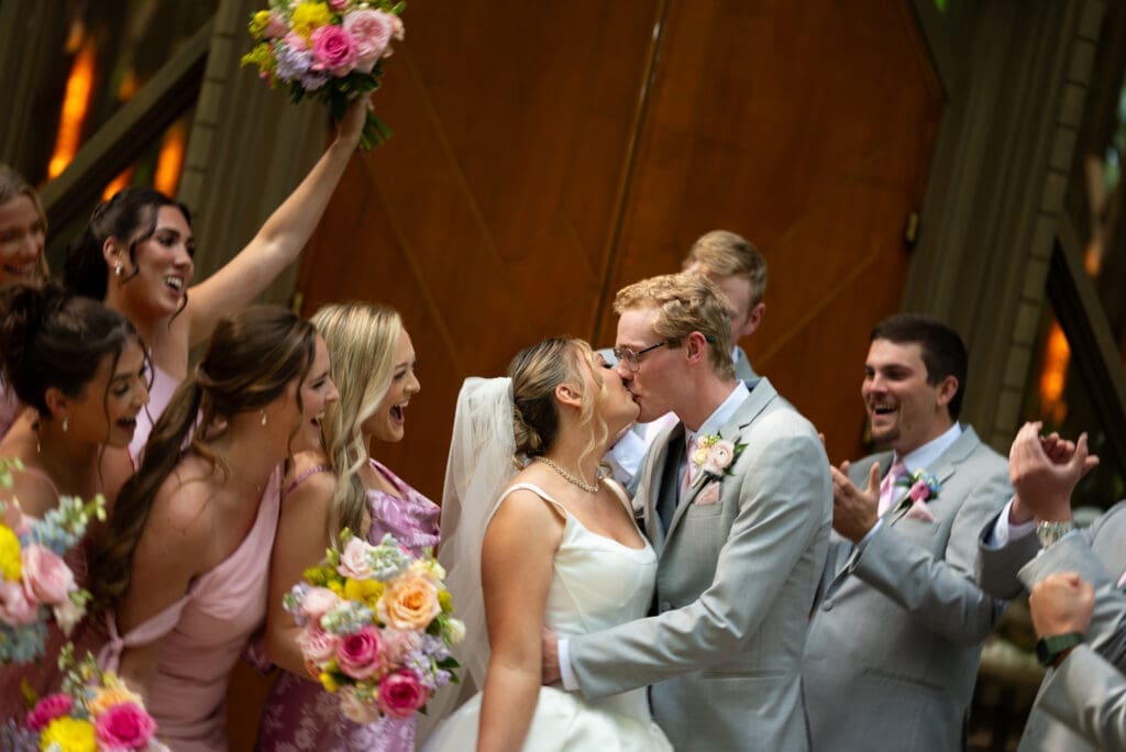 Bride and groom kissing in front of Anthony Chapel, a Hot Springs wedding venue in Arkansas. wedding photographer that travels, based out of Wisconsin.