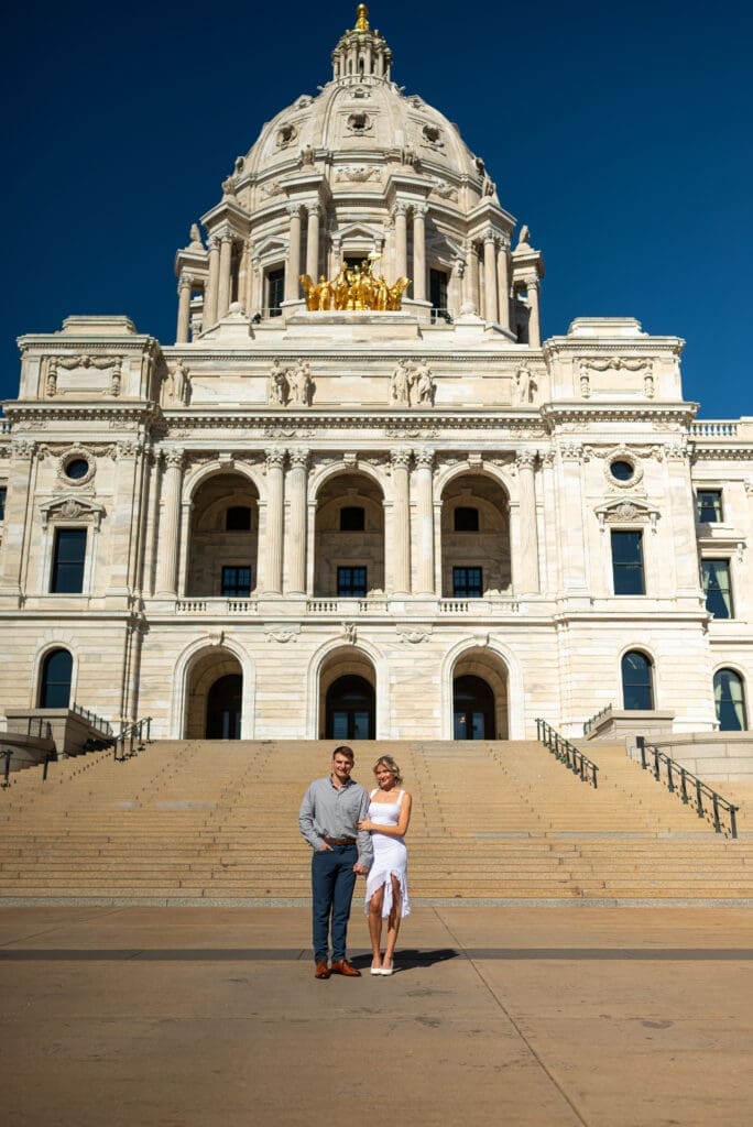 MN State Capitol engagement session St. Paul engagement photos show couple in front of the capitol, captured by Maddie, a true to color wedding photographer based out of WI