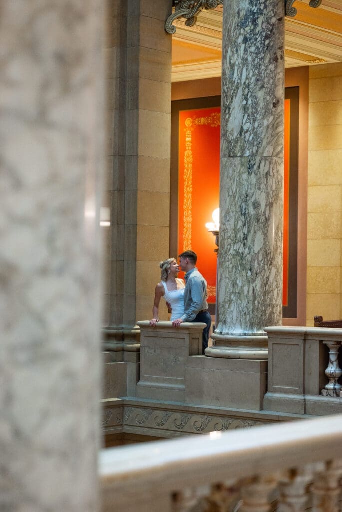 Romeo and Juliet style photo from the balcony at the MN State Capitol engagement session, by Spirited Sage Photography, a true color editorial wedding photographer