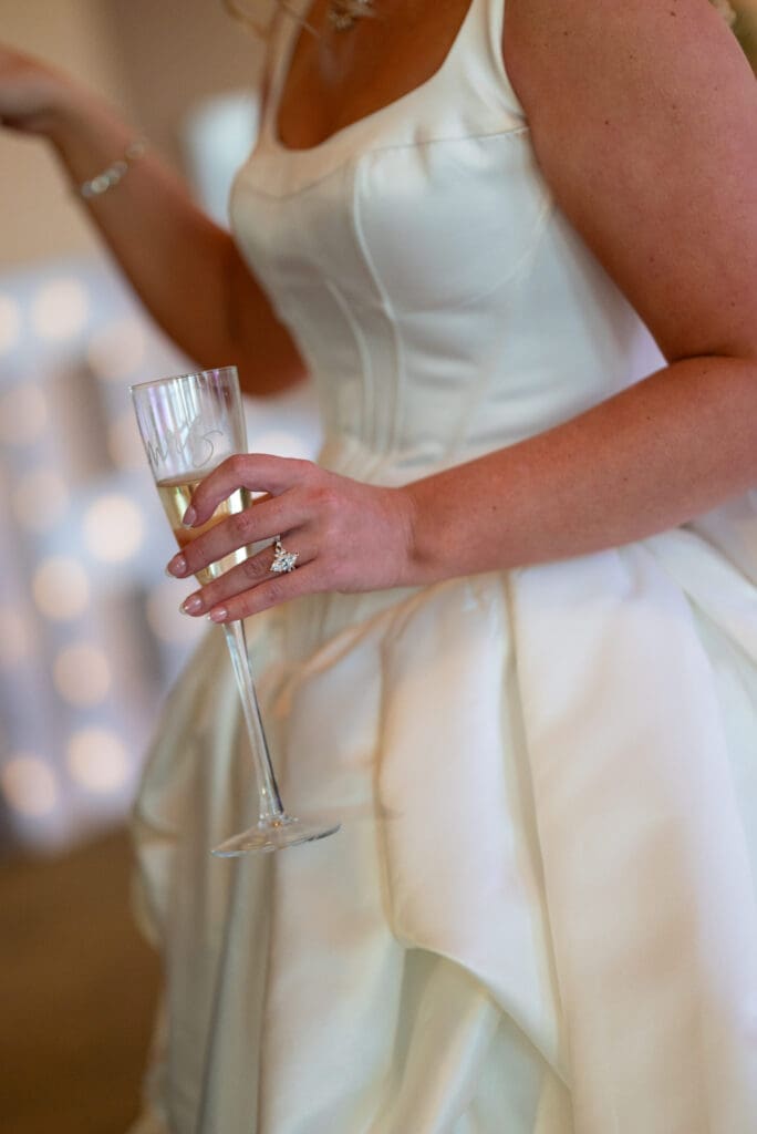 detail shot of ring and champagne at timeless country club wedding