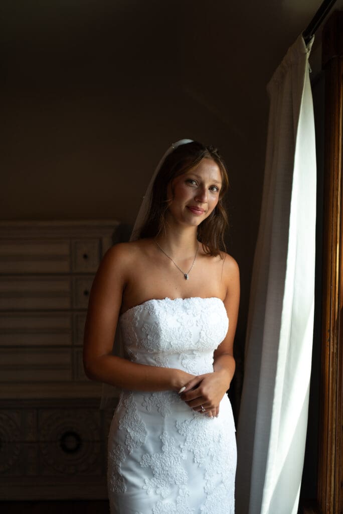 bridal portrait near window at hidden meadow and barn wedding venue in Pepin wisconsin. Pepin wisconsin wedding photographer