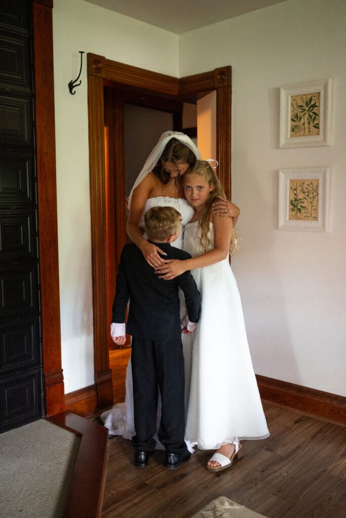 bride and family embrace. best wedding photographers near me