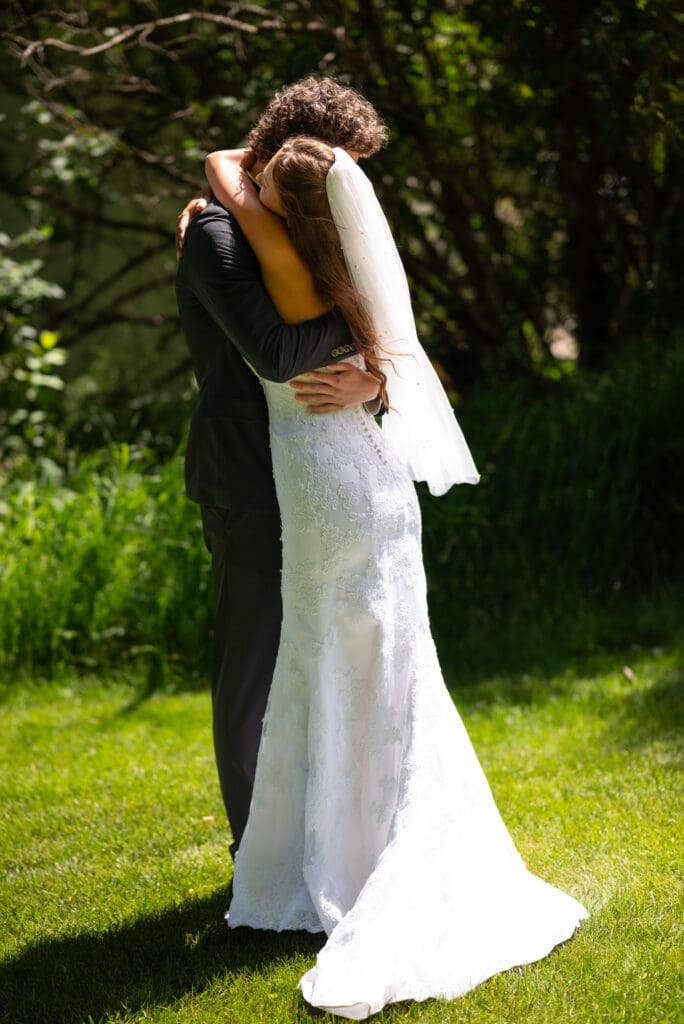 bride and groom embrace after first look at their Pepin, WI wedding venue.