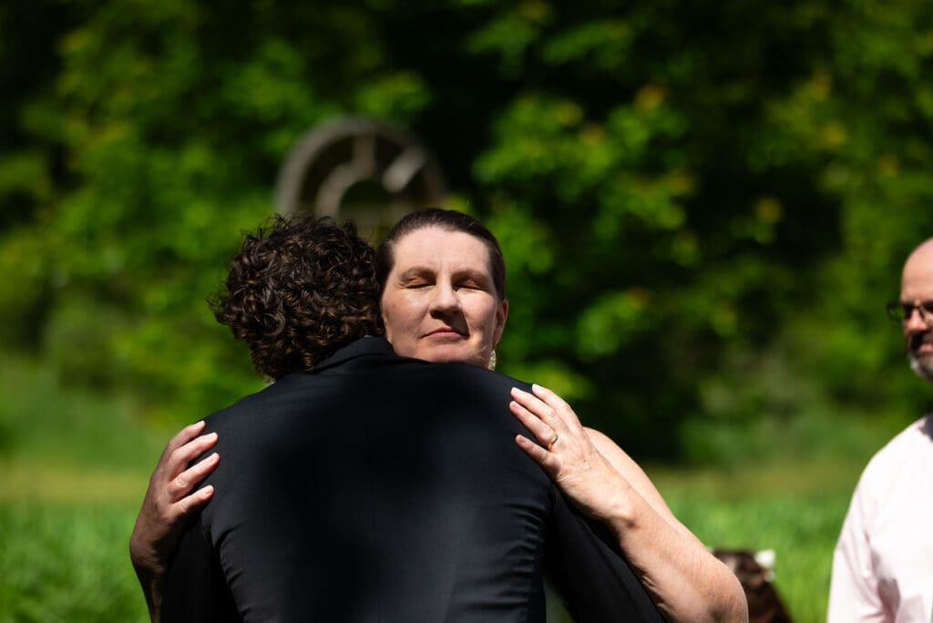 mother of groom hugs groom
