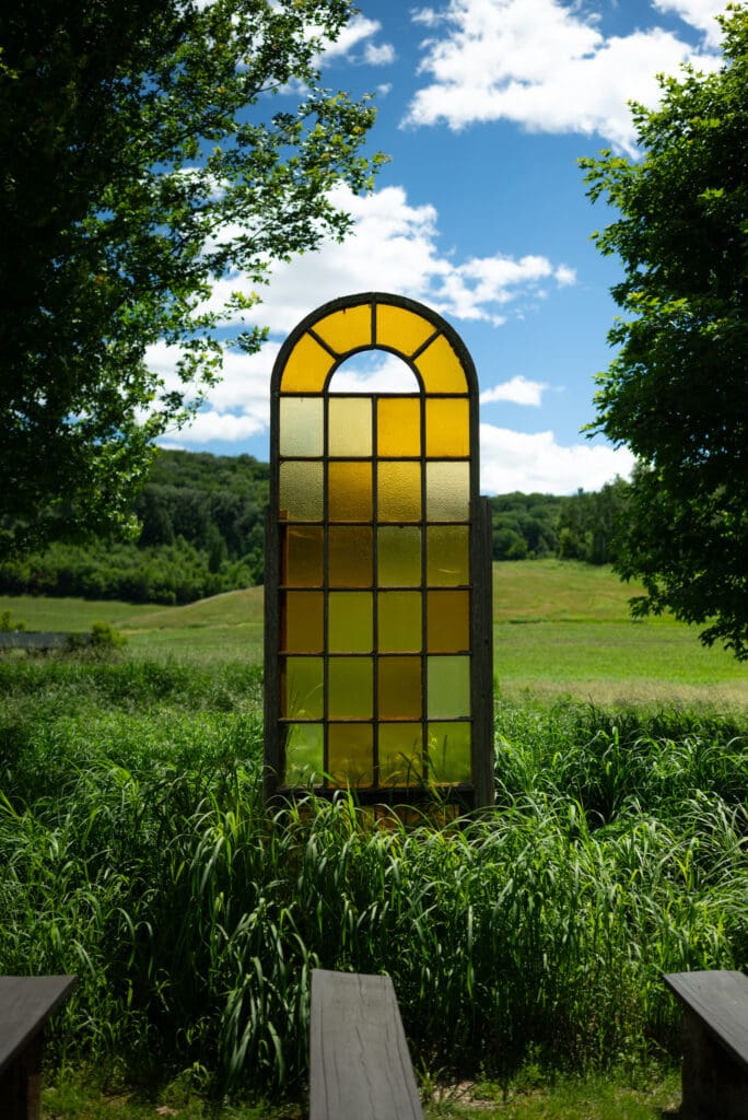 stained glass window at outdoor wedding ceremony space at hidden meadow and barn in Pepin, WI. Wisconsin wedding photographer. wedding venues near La Crosse, WI