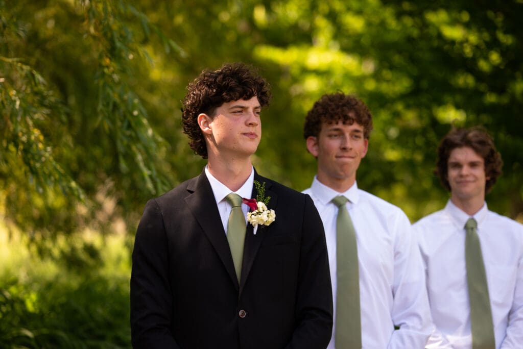 groom watches bride come down aisle at Pepin, Wisconsin wedding venue