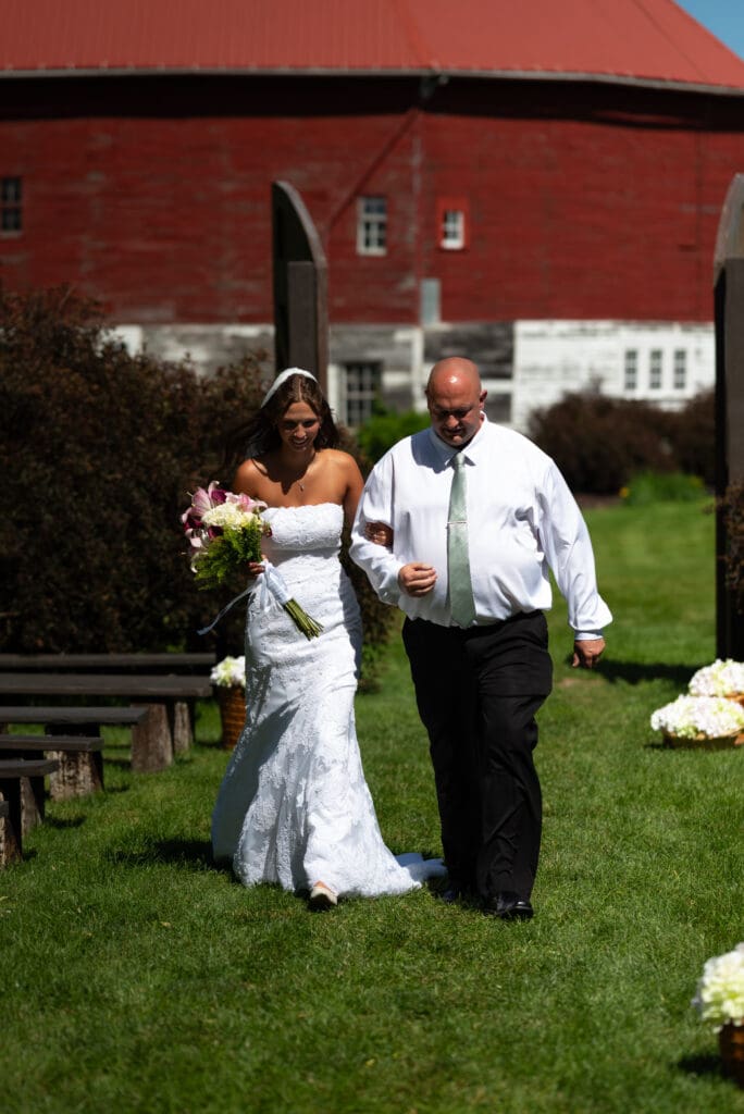 bride and father walk down aisle at outdoor wedding venue in Pepin