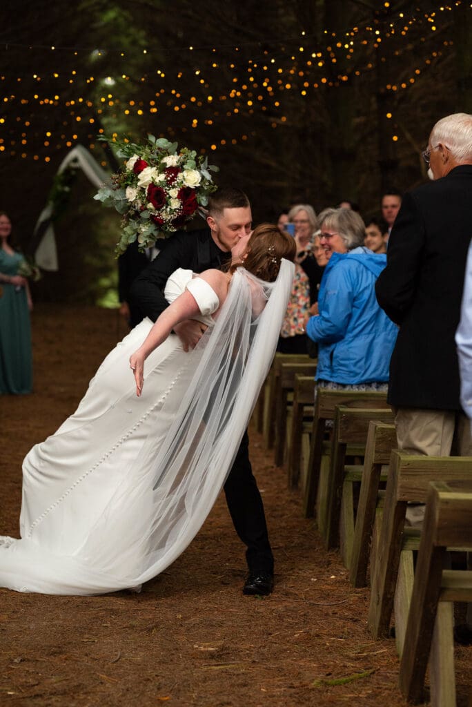 dip kiss down the aisle outdoor wedding ceremony