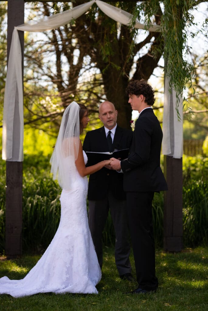 bride and groom say vows at their wedding venue in Pepin