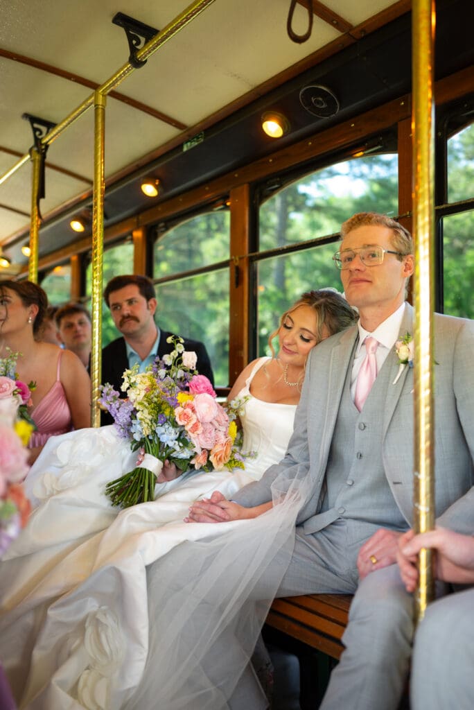 Bride and groom on trolley. Available wedding photographers near me in Wisconsin