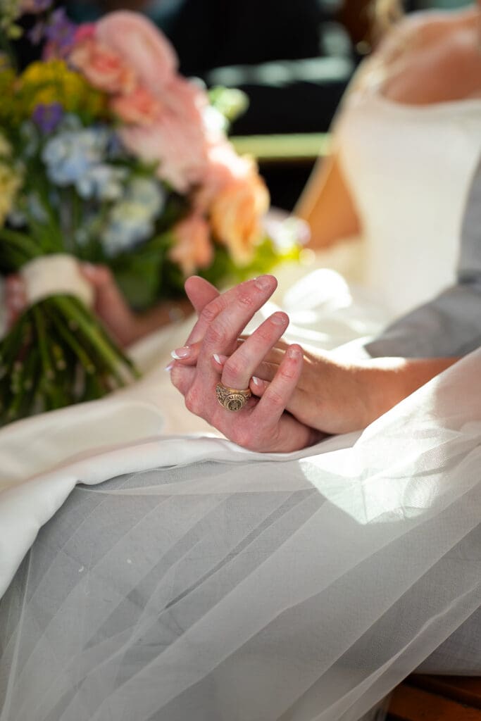 detail photo of bride and groom holding hands. True color Eau Claire photographer