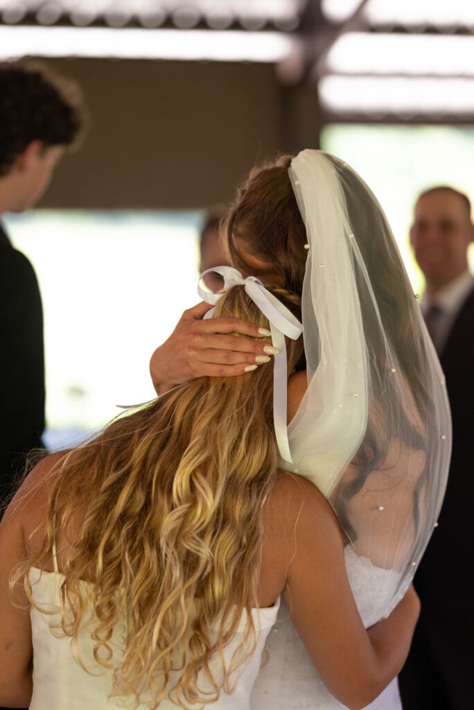 bride and flower girl embrace. wedding venues near pepin, WI