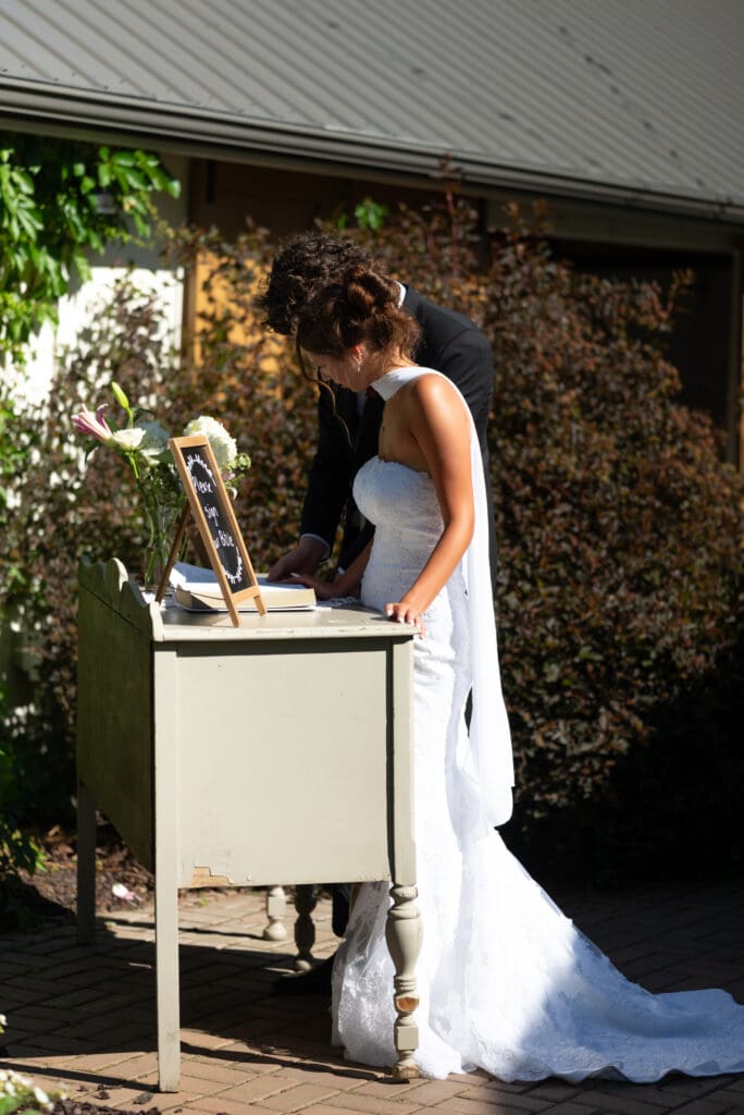 bride and groom view guestbook at their pepin wedding venue