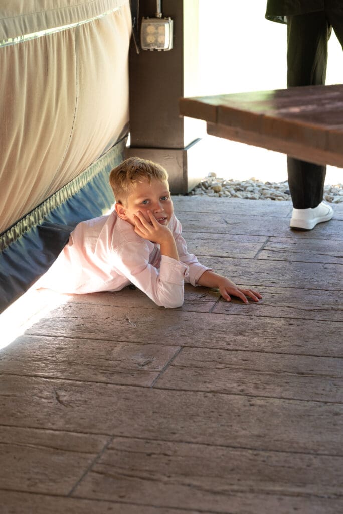 boy hides under tent at wedding reception in pepin wisconsin