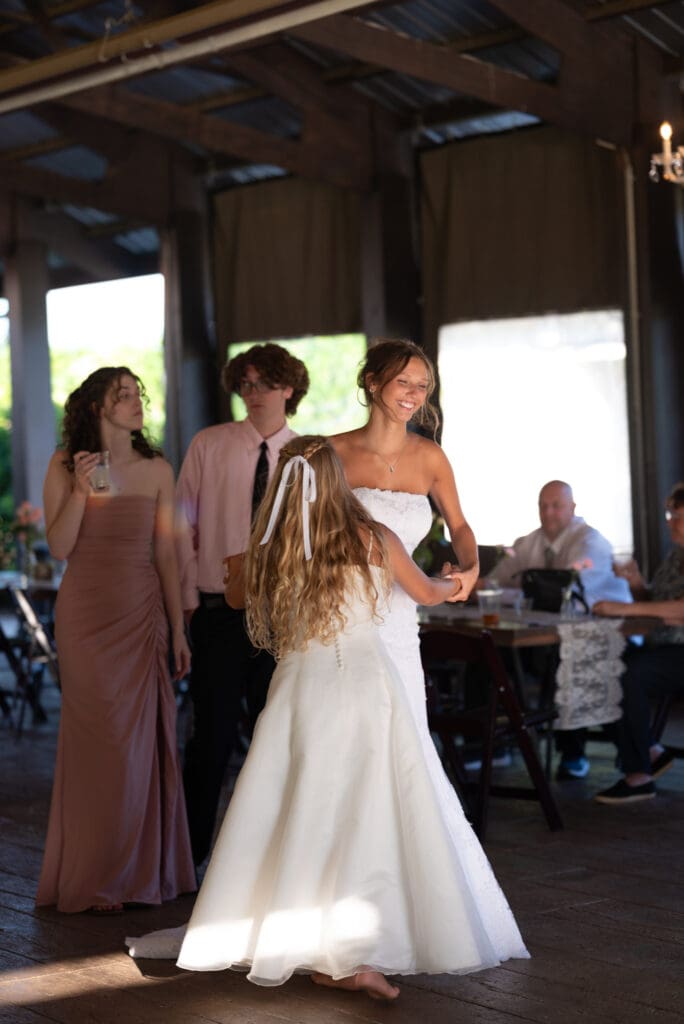 bride and flower girl dancing