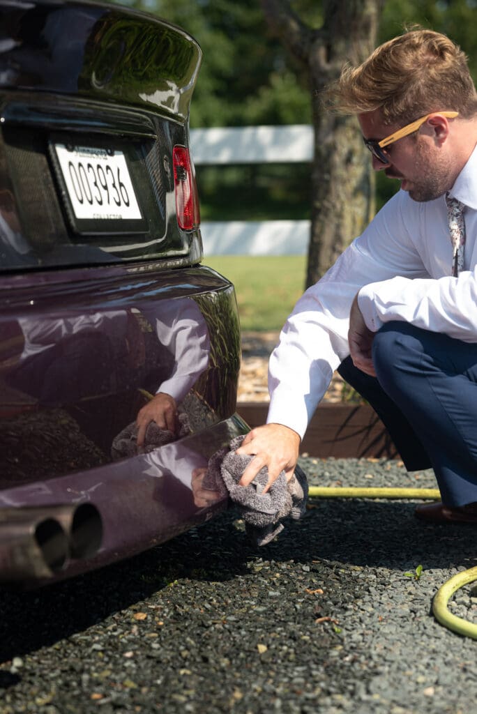 groom cleaning car before wedding