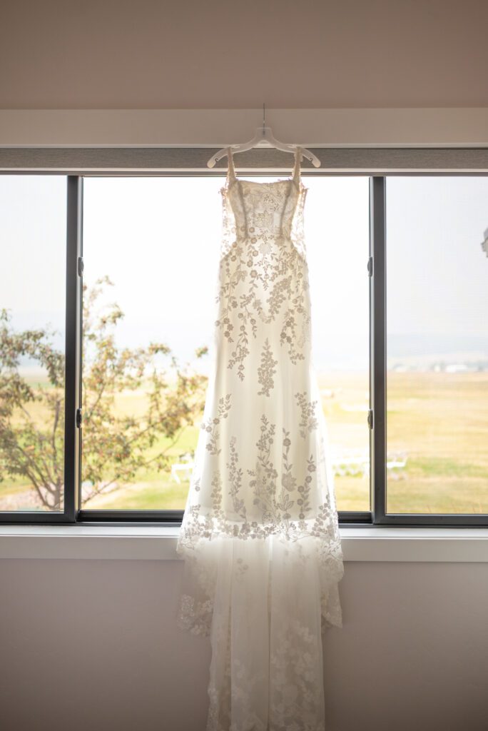 Bride's dress hanging at Montana AirBnB for her micro wedding