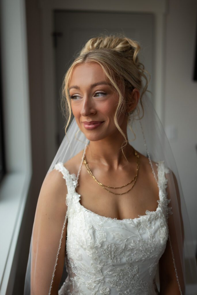 Bridal portrait near window with natural light ahead of this bride's Glacier National Park micro wedding