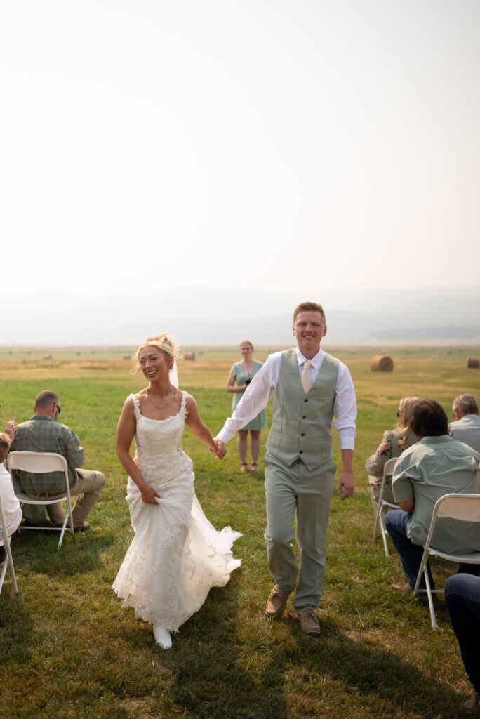 Walking down the aisle as newly weds after their intimate micro wedding in Montana