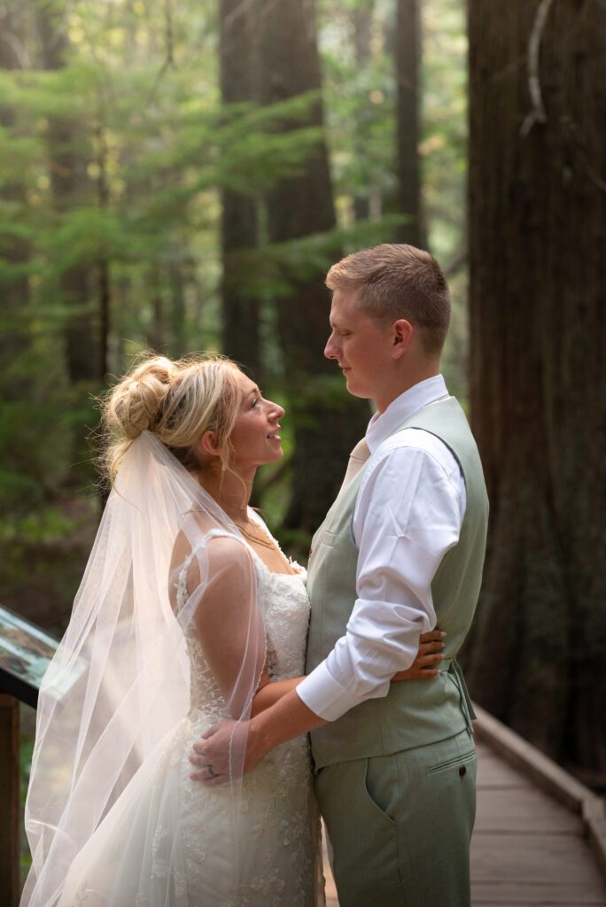 Bride and groom in the old growth forest along the Trail of Cedars Trail in Glacier National Park