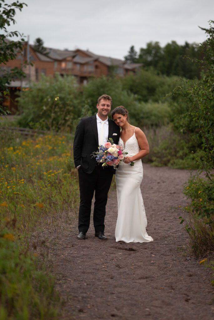 bride and groom wedding portrait in front of Superior Shores Resort in Two Harbors, MN