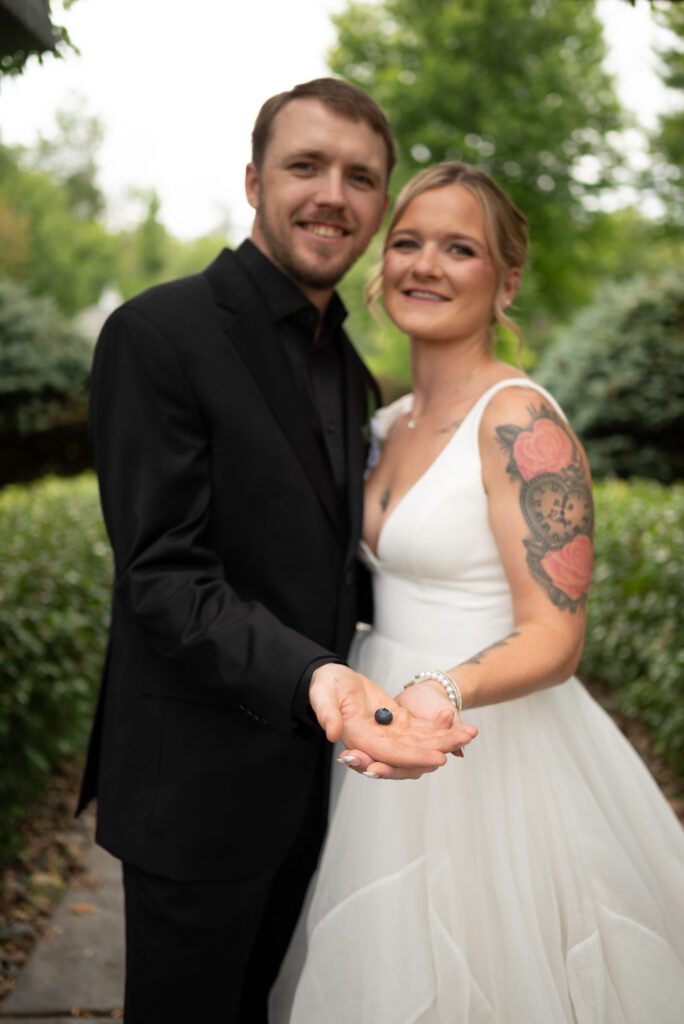 Bride and groom baby announcement using blueberry for the size of baby