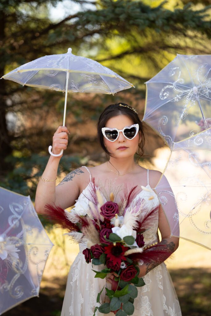 editorial bridal portrait of tattooed bride with vintage inspired sunglasses and parasol