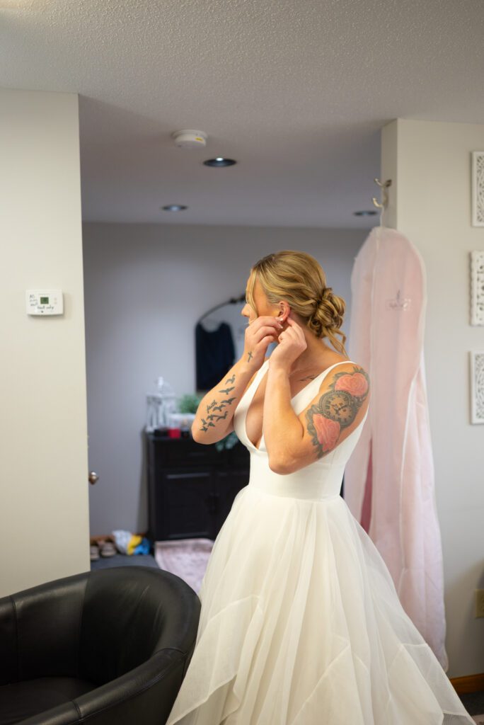 Bride putting on earrings at Baldwin wedding venue