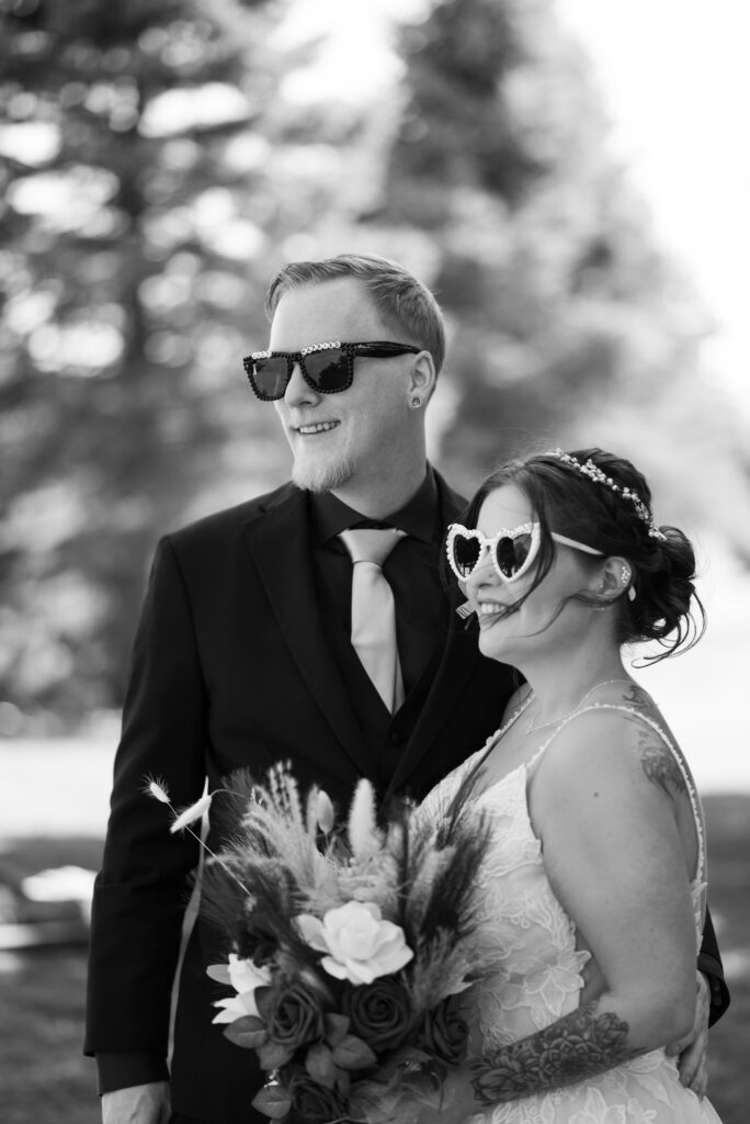 side profile of bride and groom smiling for guest's camera