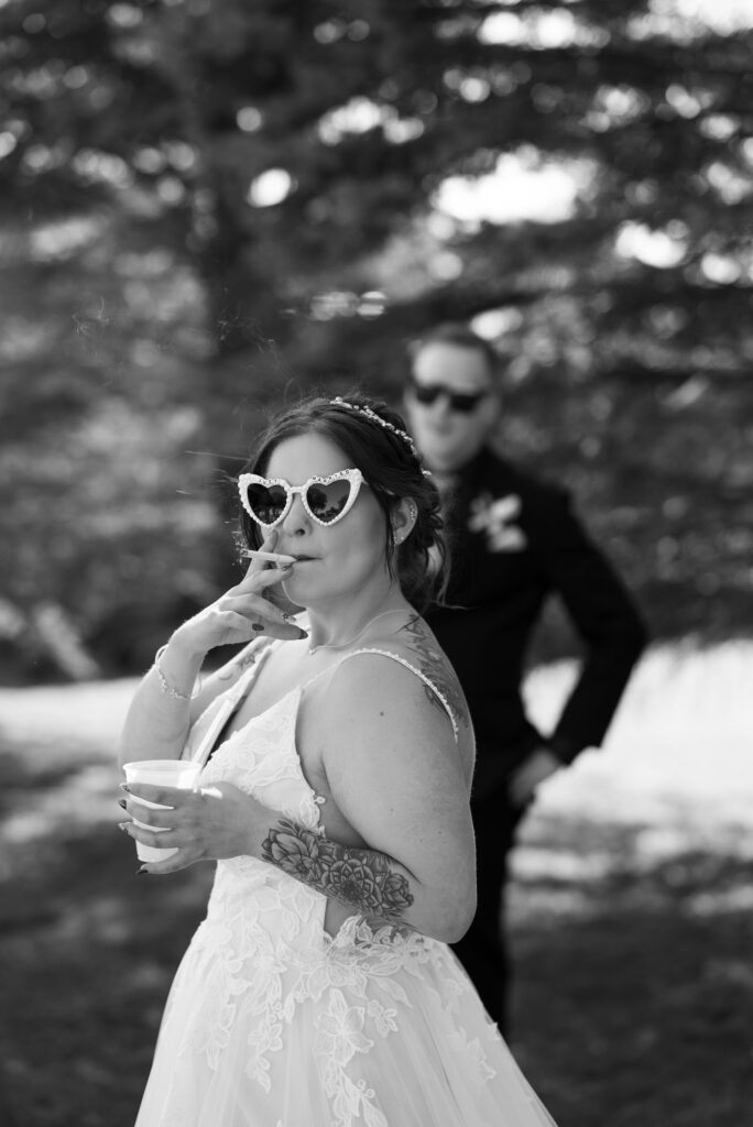 editorial shot of tattooed bride smoking cigarette before wedding