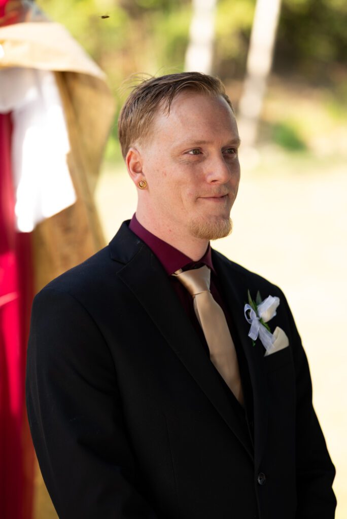 groom watching bride come down aisle