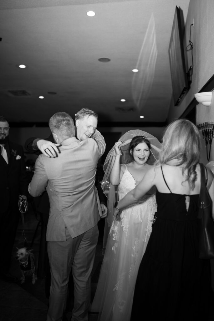 black and white editorial image of bride and groom receiving line