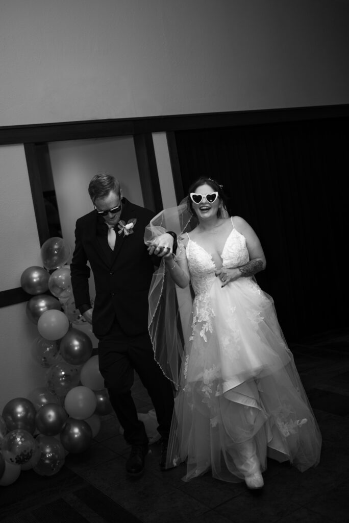 black and white flash photo of bride and groom grand entrance