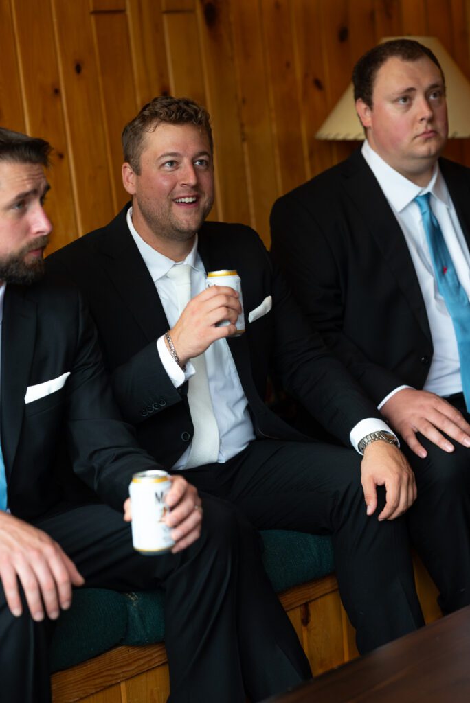 groom and his guys watching football before the ceremony