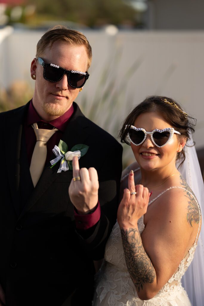 bride and groom showing off rings
