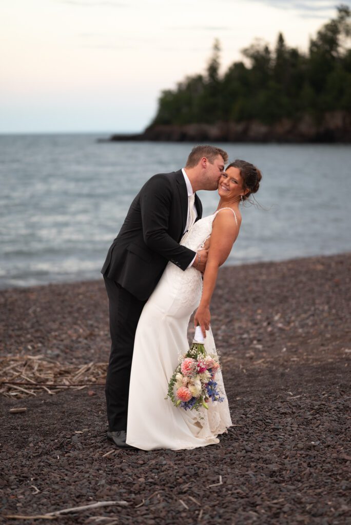 bride and groom portrait on the beaches of the MN North Shore Lake Superior