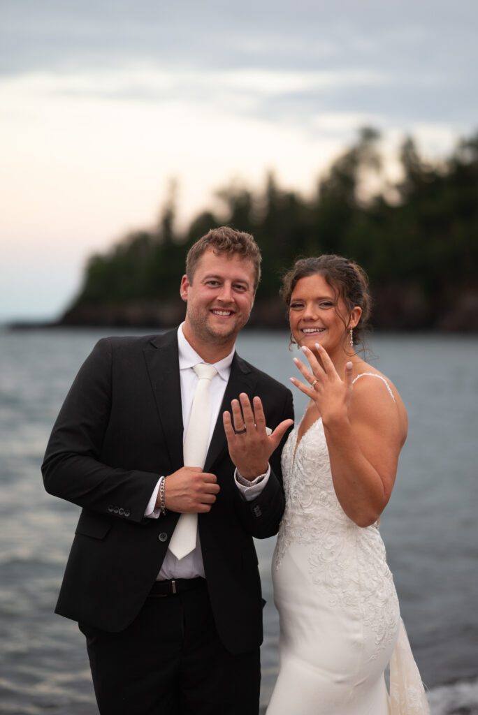 bride and groom showing off their rings