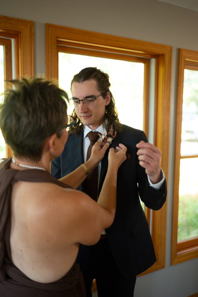 mother of groom helping groom