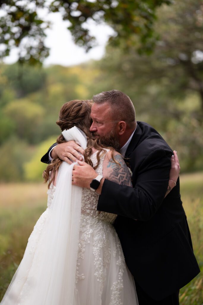 Bride and father hugging after first look