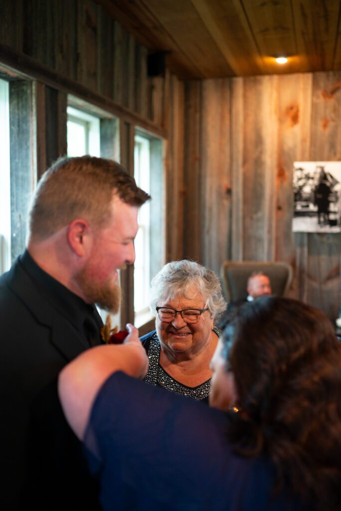 Grandma helping groom get flowers on