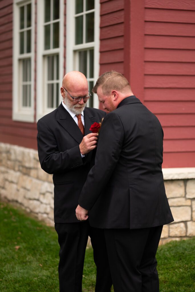 groom getting ready with his dad