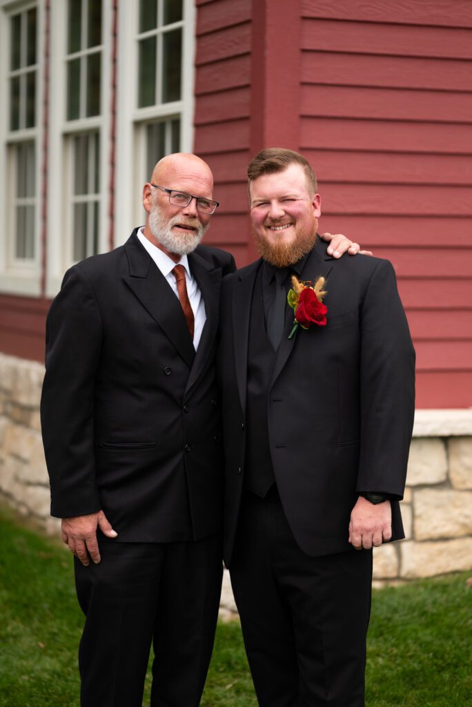 groom and father of groom smiling for the camera