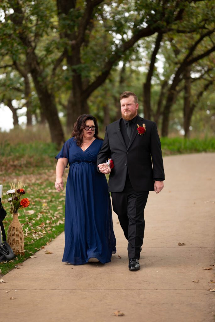groom and mom walking down aisle