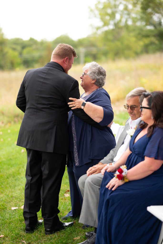 groom hugging grandma before ceremony