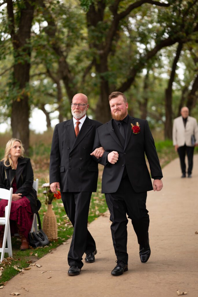 groom and father walking down the aisle