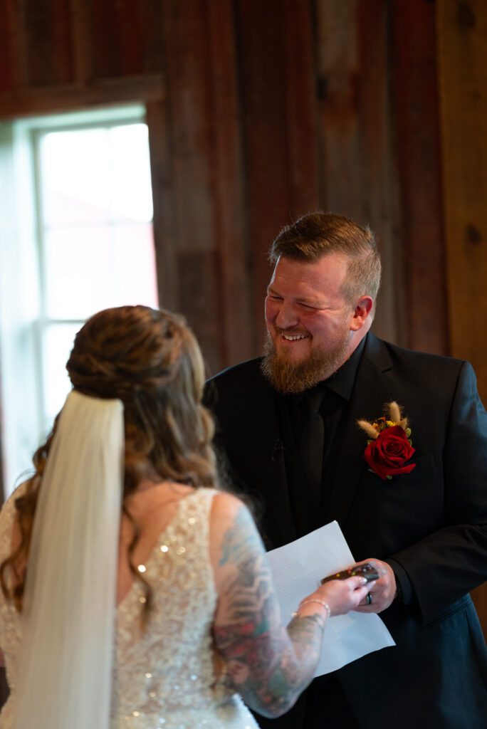Groom laughing with Bride at private vows