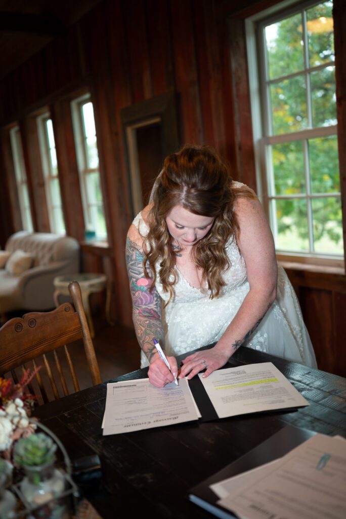 bride signing marriage certificate