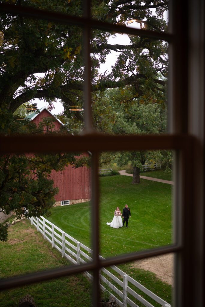 through the window wedding photo at Almquist Farm wedding venue in Hastings, MN